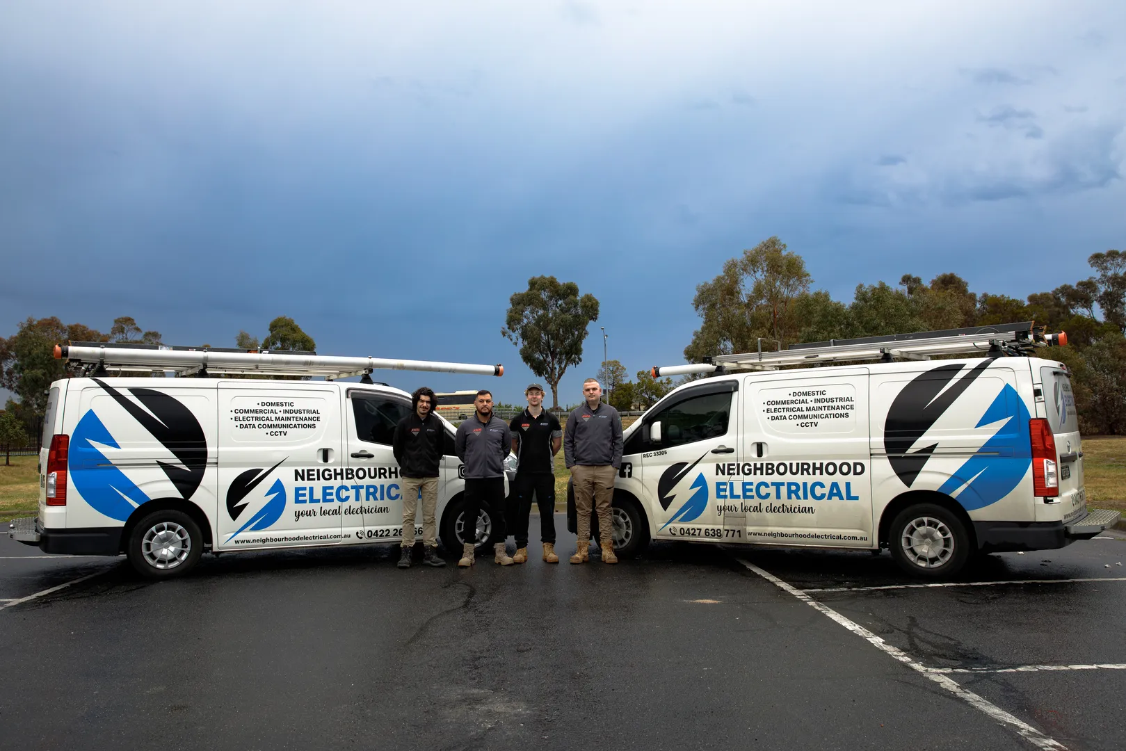 Neighbourhood Electrical team with service vans in background.